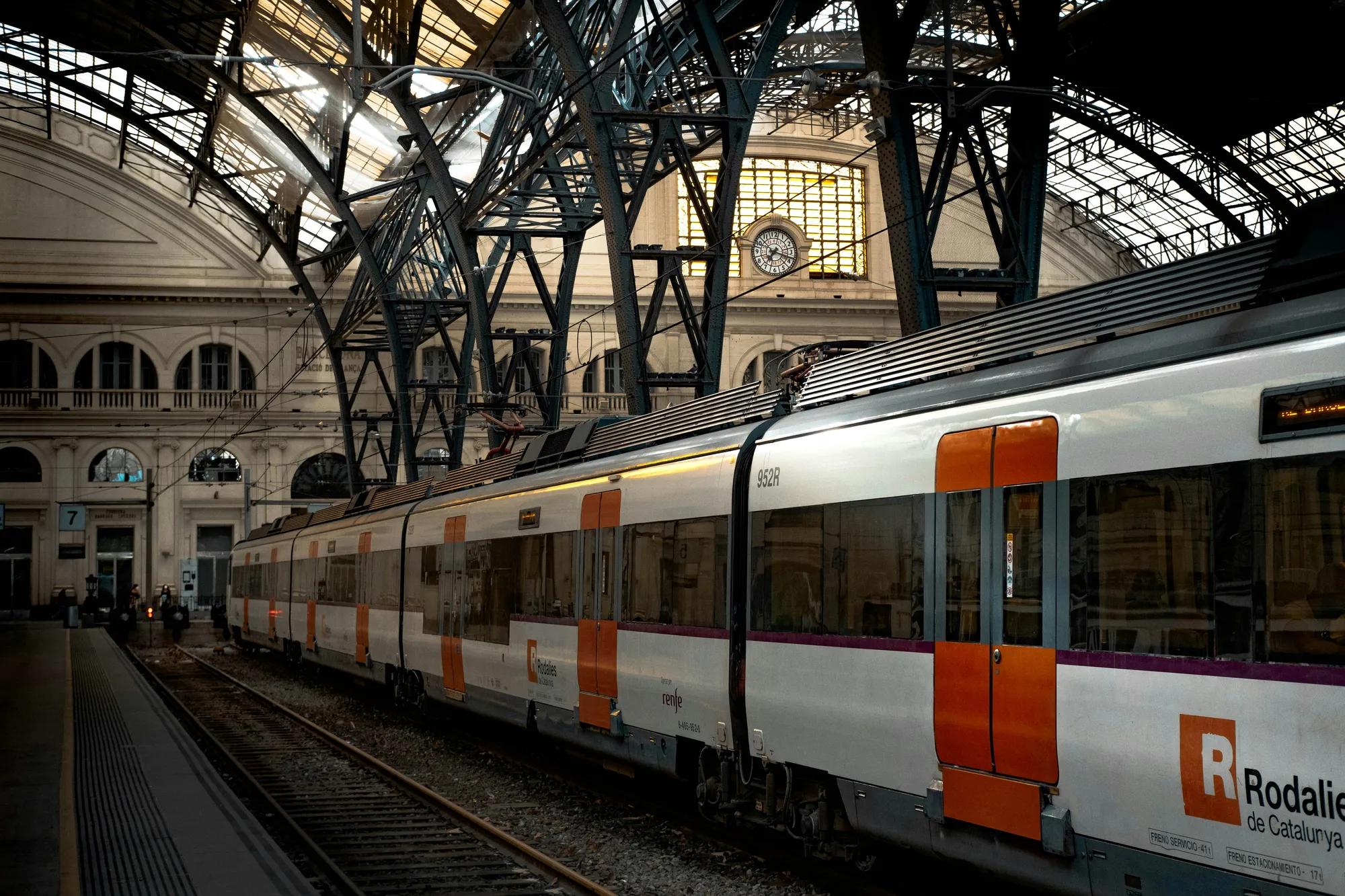 White red and black train on rail tracks.
